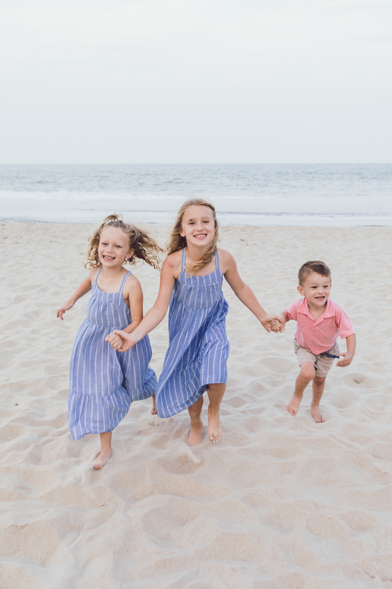 Kids playing in the sand during a Bethany Beach photo session