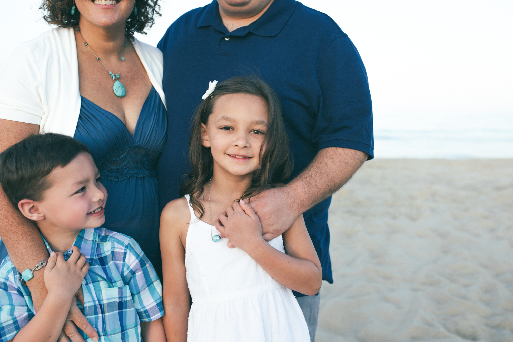 Family walking along the ocean at Bethany Beach